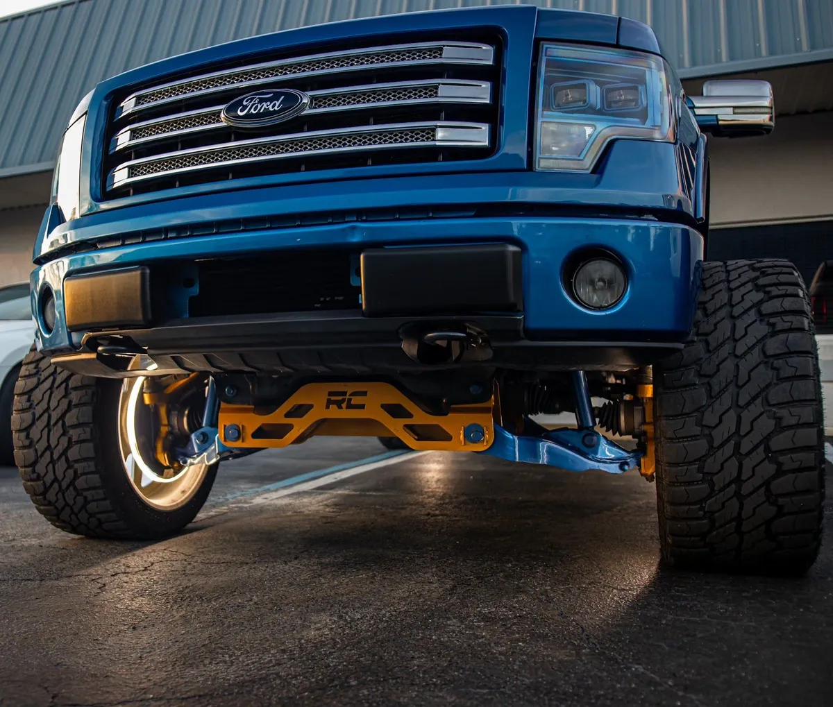 Blue Ford truck with gold suspension parts