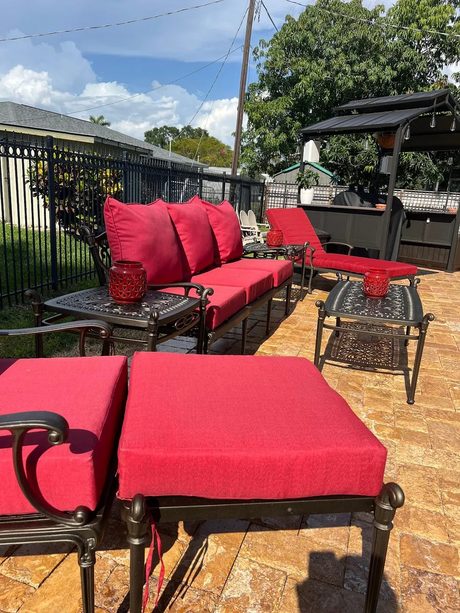 Outdoor patio set with dark frames and red cushions